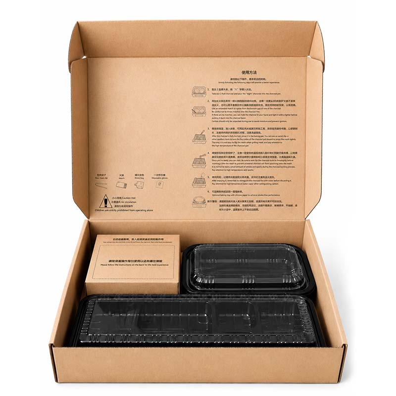 Open disposable charcoal grill bento box with trays